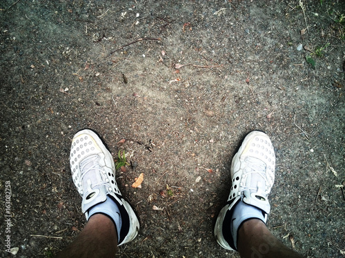 Feet in shoes on the ground