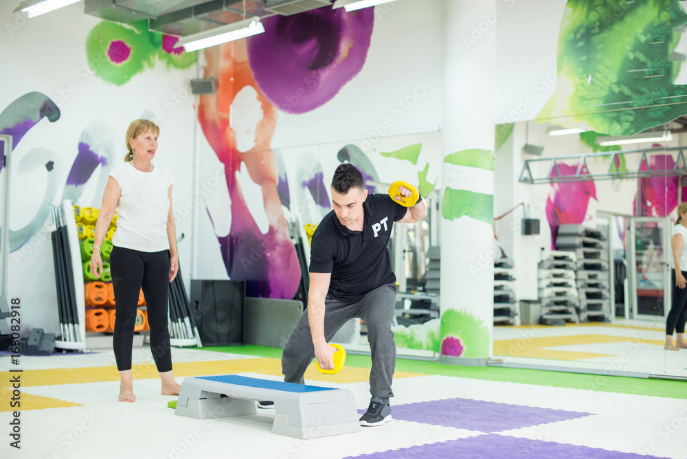 Fototapeta premium Showing arms exercise
