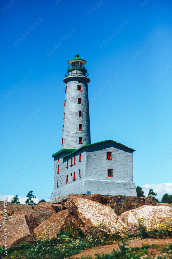 the layout of the Lighthouse on sand dune against blue sky with white clouds