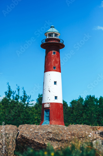the layout of the Lighthouse on sand dune against blue sky with white clouds