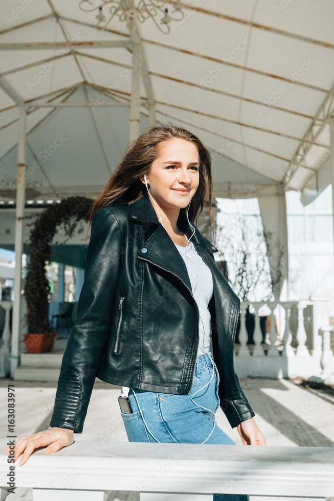 Beautiful Woman In A Black Jacket White Tshirt And Black Jeans On