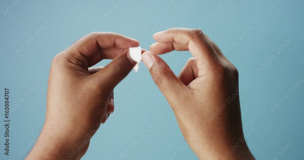 mixed race man's hand open a fortune cookies