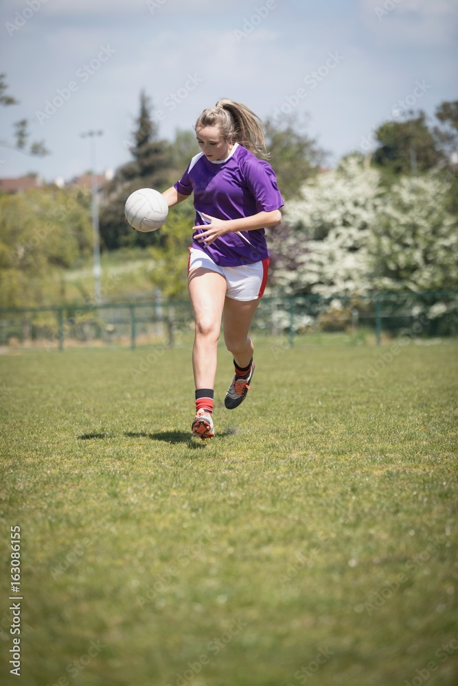Full length of woman running with soccer ball Full length of woman running with soccer ball