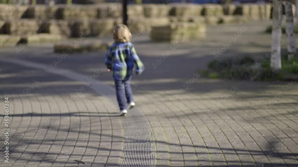 Happy Little Boy Runs On A Line In A Park Happy Little Boy Runs On A Line In A Park