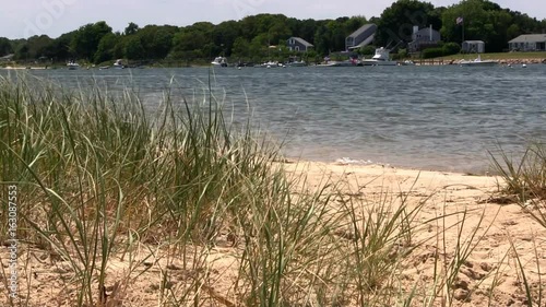Sand and beach grass on Washburn island looking out over childs river on Cape Cod at waterfront homes and prime real-estate photo