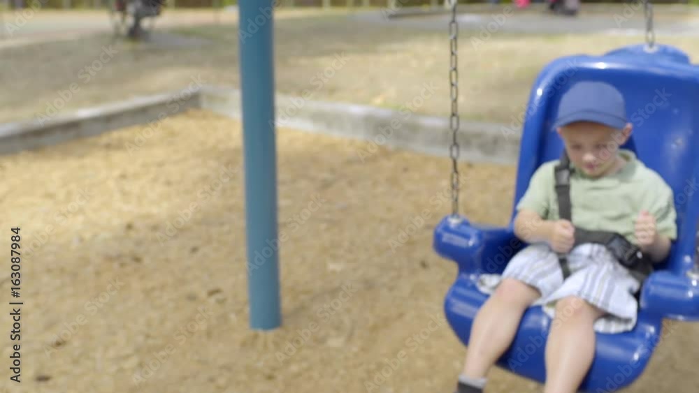 Happy Little Boy Swings In Park, Gives Two Thumbs Up Happy Little Boy Swings In Park, Gives Two Thumbs Up