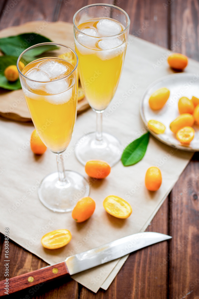 cocktail with kumquat on wooden background cocktail with kumquat on wooden background