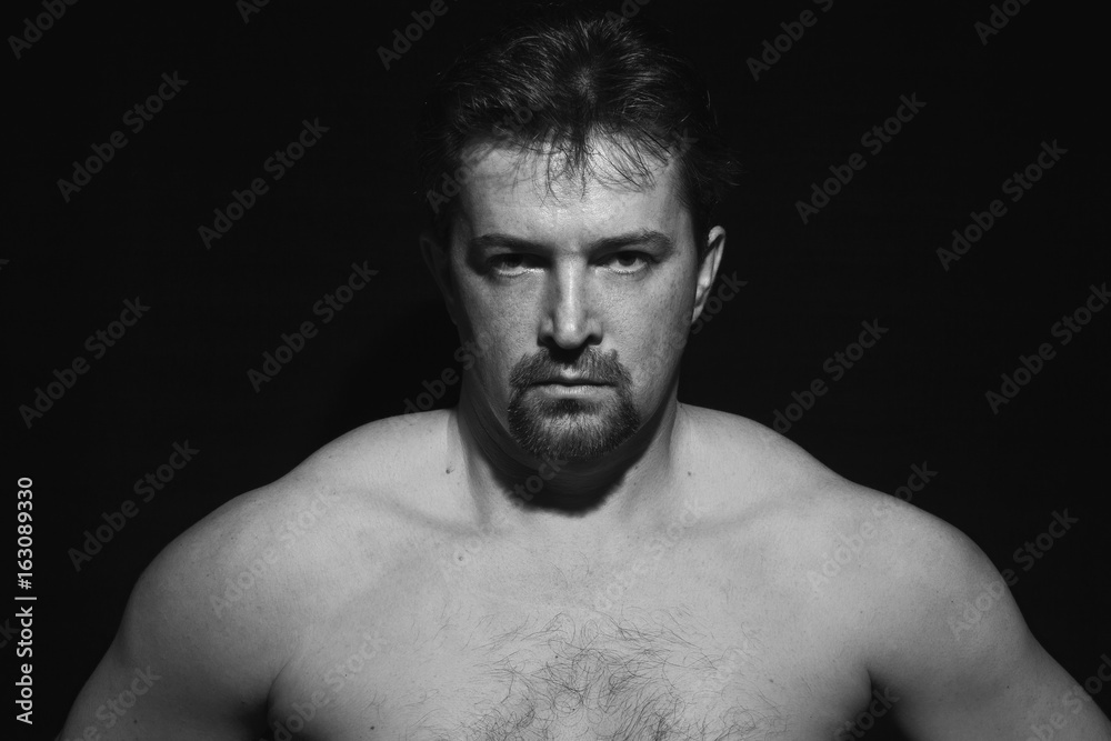 Fototapeta premium Muscular man showing his muscles