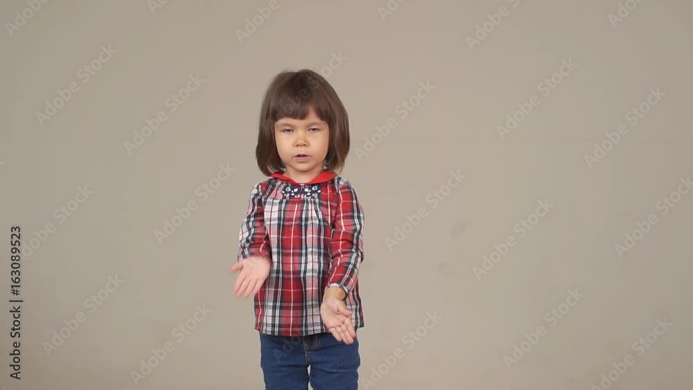 Funny little girl posing at the camera. Girl in shirt and jeans Funny little girl posing at the camera. Girl in shirt and jeans