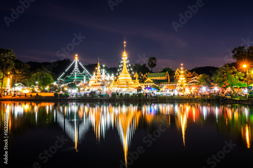 Water Reflections of Wat Phra That Nhong Jong Kham temple backdrop Beautiful sky at sunset in Meahongson. Thailand photo