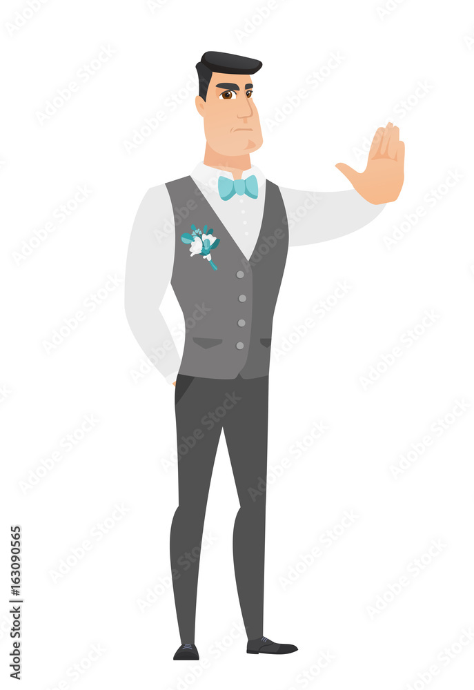 Caucasian groom showing stop hand gesture.