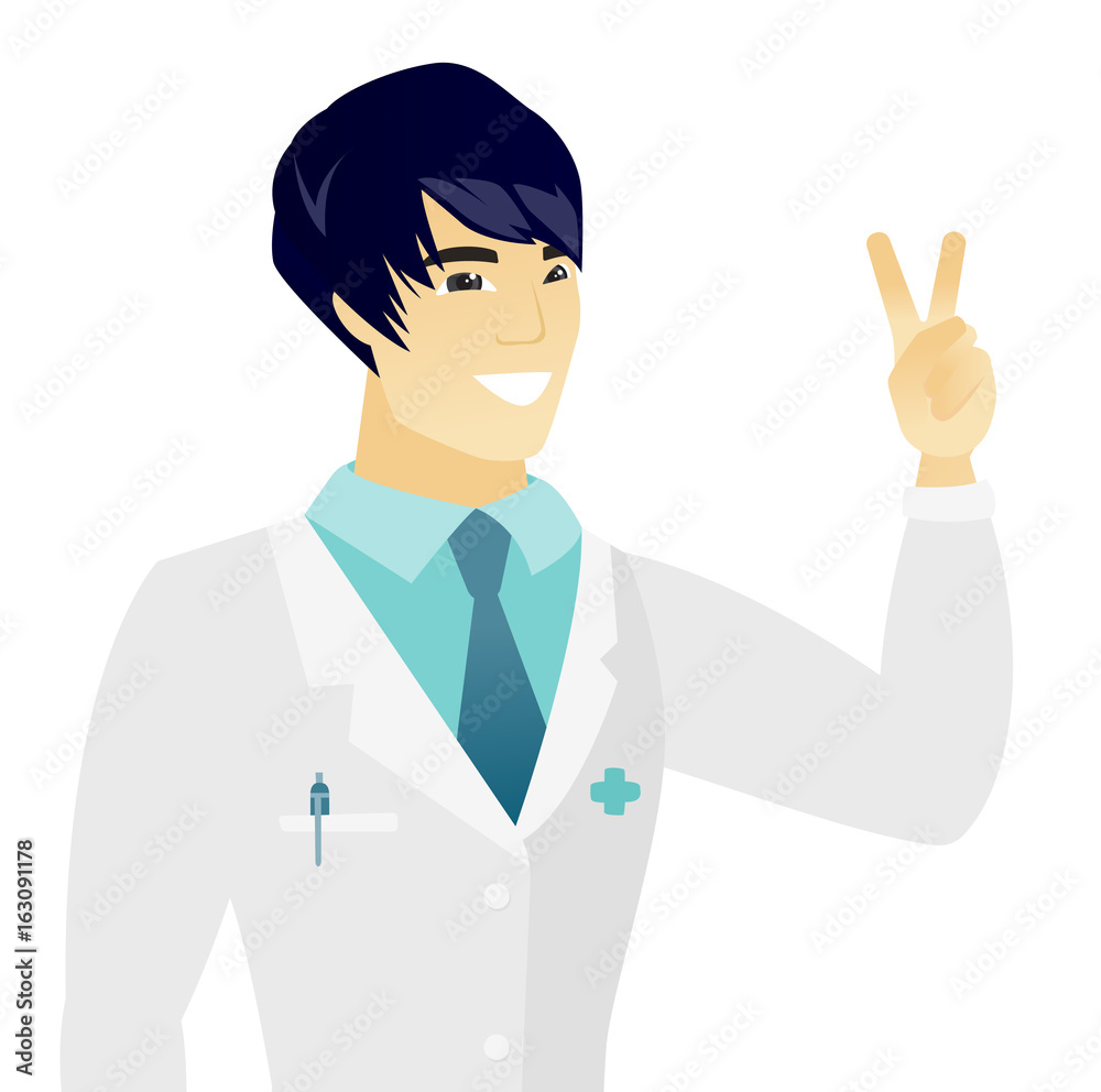 Young asian doctor showing the victory gesture. Young asian doctor showing the victory gesture.