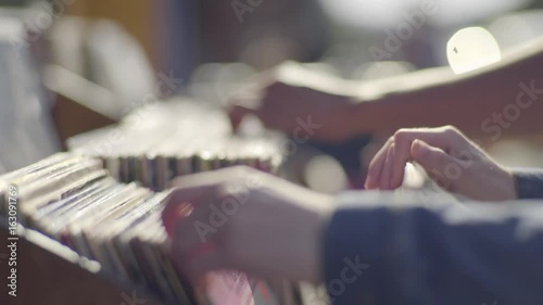 Couple Stand Side By Side, Sort Through Old Records Together At A Sidewalk Sale 