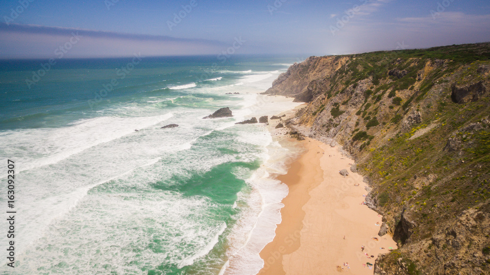 Aerial view of peoples resting on Praia da Adraga beach in Portugal, Almocageme, Sintra