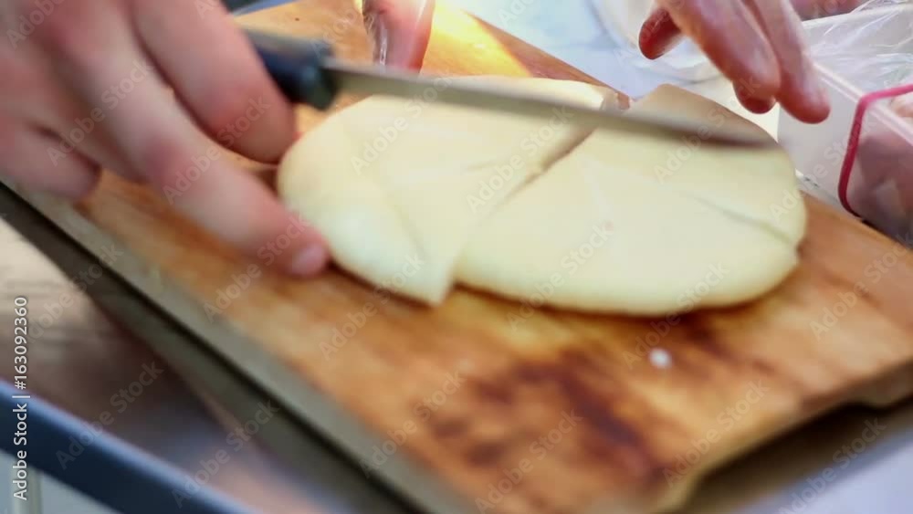 Chief cook slicing the pita - arabian bread