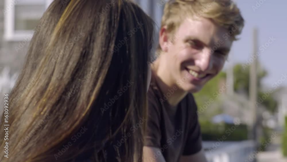 Closeup Of Multiethnic Teens Chatting On A Bridge And Enjoying View Closeup Of Multiethnic Teens Chatting On A Bridge And Enjoying View