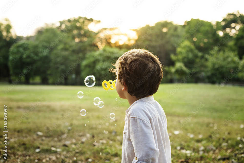 Children is playing bubbles in a park Children is playing bubbles in a park