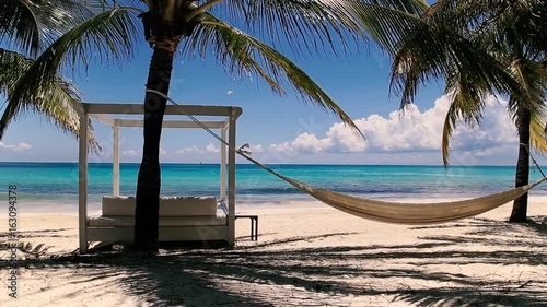 Empty bed and hammock at exotic beach. Color graded shot. Audio included.