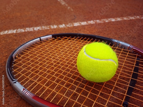 Tennisschläger mit Tennisball auf einem Tennisplatz © pattilabelle