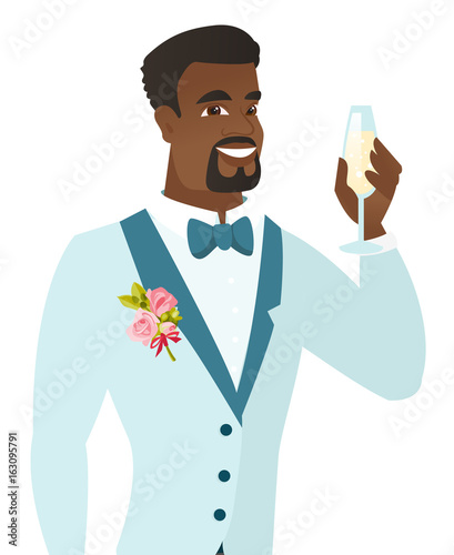 African-american groom holding glass of champagne.