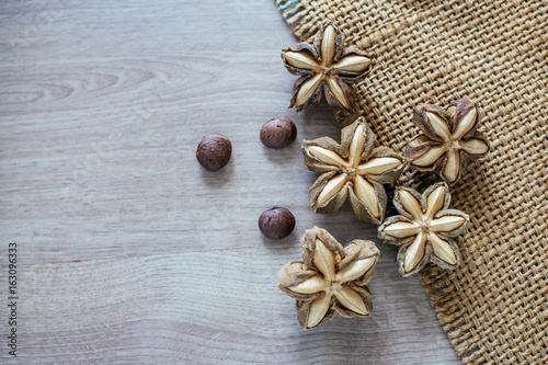 Sacha inchi peanut seed on wooden background. To eat as medicine or processed into products.