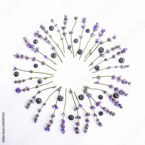 Fresh lavender flowers and blueberries arranged in circle on a white background. Lavender flowers and blueberries mock up.