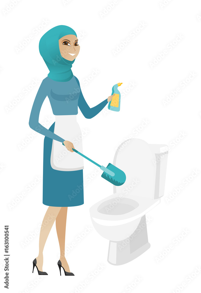 Muslim cleaner in uniform cleaning toilet bowl. Muslim cleaner in uniform cleaning toilet bowl.
