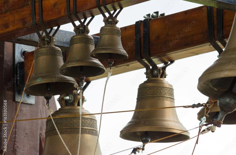 Bronze bells on  beam in belfry