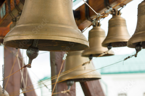 bronze bells on beam in belfry closeup