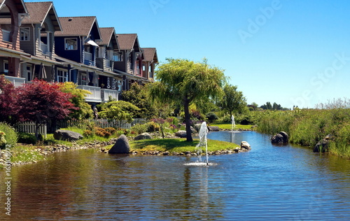 New residential area in a picturesque location near a pond with a fountain in the city of Richmond