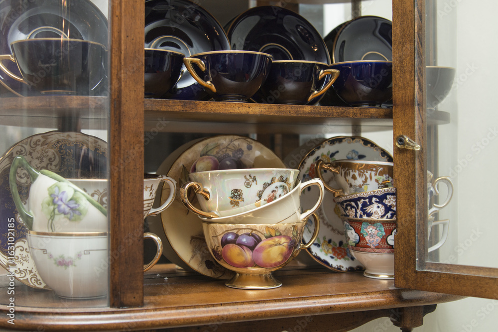 Vintage curio with porcelain tea cup collection Stock Photo