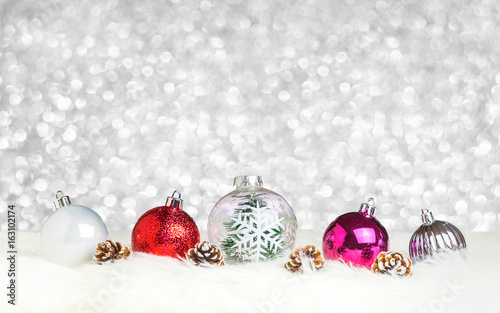 Christmas decoration ball on white fur at silver bokeh light background,Holiday greeting card