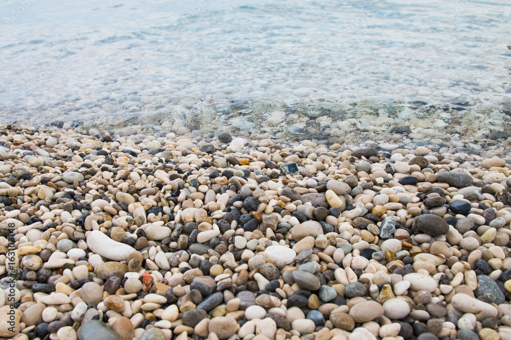 Pebbles on the beach. Time to relax. Summer and season of travel. Sea and beach
Pebbles on the beach. Time to relax. Summer and season of travel. Sea and beach