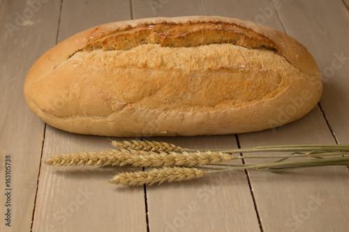 homemade baked bread flour and wheat on light wooden background photo