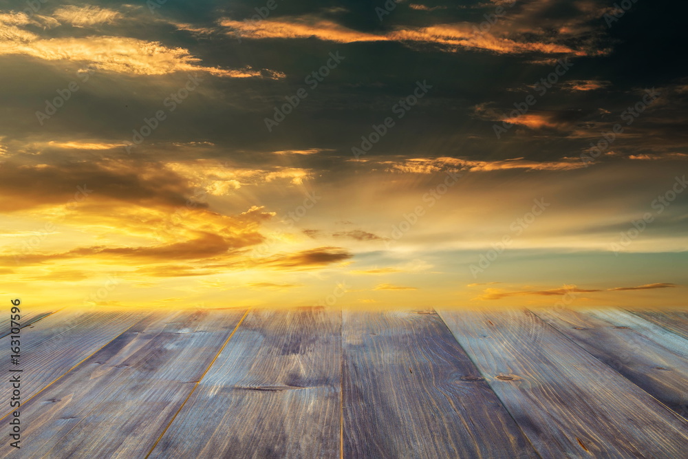 Wooden floor and colorful of sky when sunset in the background , blurred effect