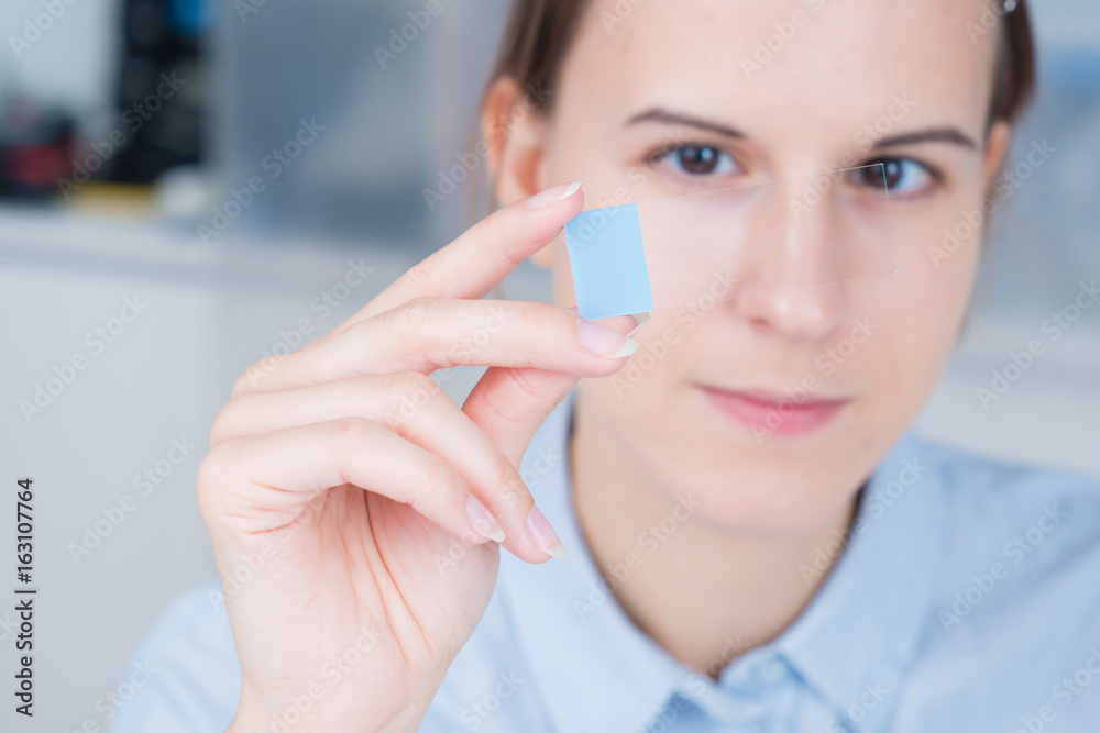 student girl with glass empty microscope slide in hand student girl with glass empty microscope slide in hand