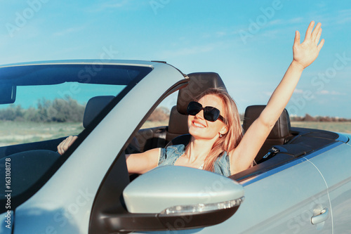 Relaxed happy woman traveling in a car