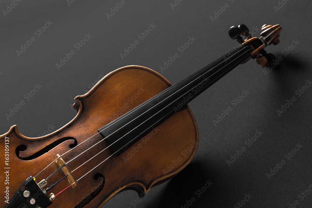 Fototapeta premium Old violin on a black background