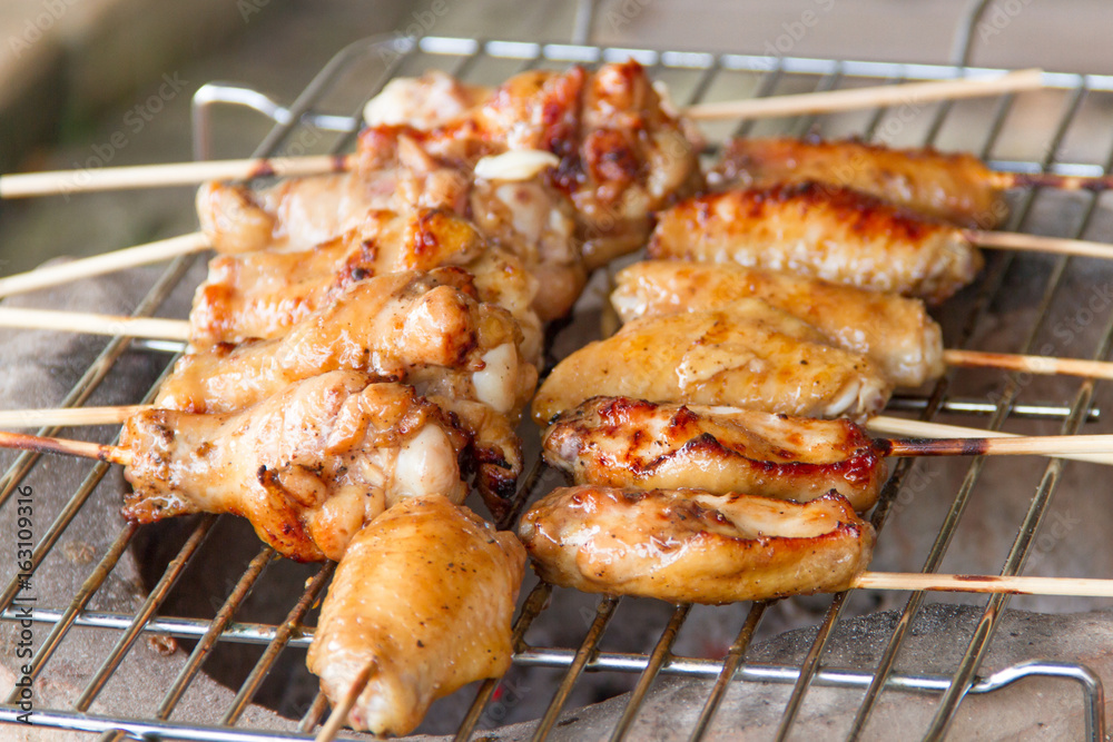 Chicken grilled on charcoal grills