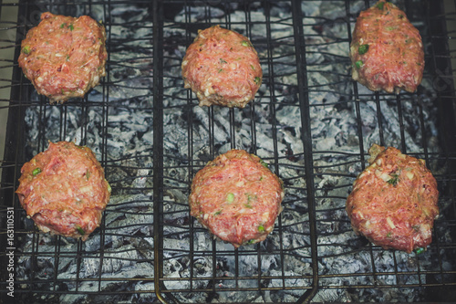 Fry the cutlets on an open fire on the grill - bbq (burgers)