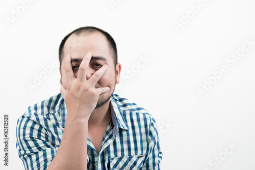 Man covering his face isolated on white background.