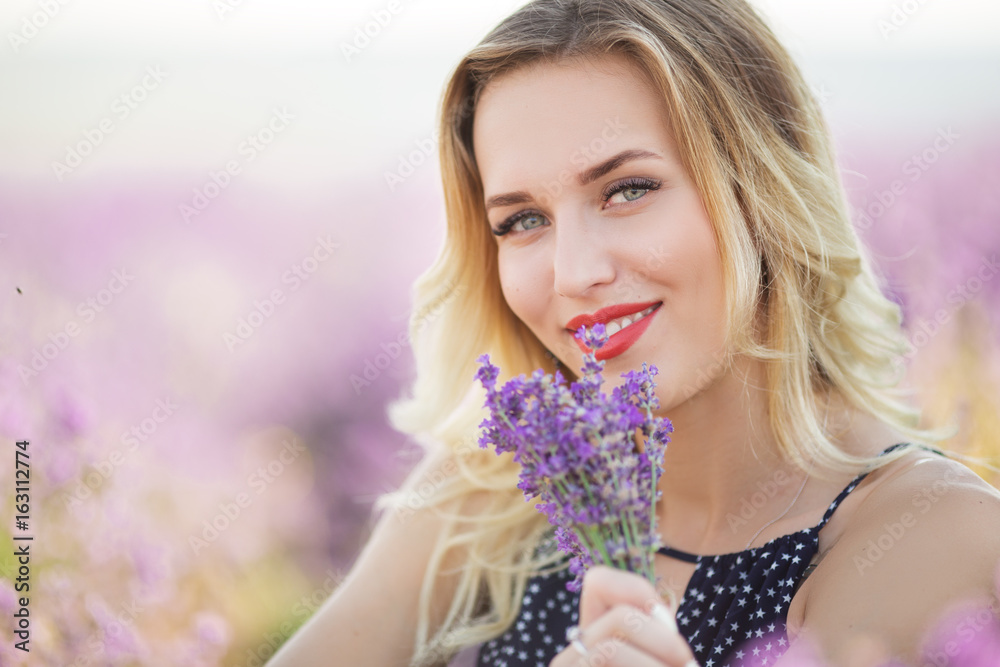 Portrait of beautiful sexy girl lying on the lavender field