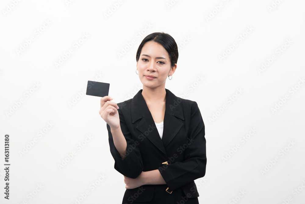 Portrait of young smiling asian business woman holding empty credit card isolated on gray background Portrait of young smiling asian business woman holding empty credit card isolated on gray background