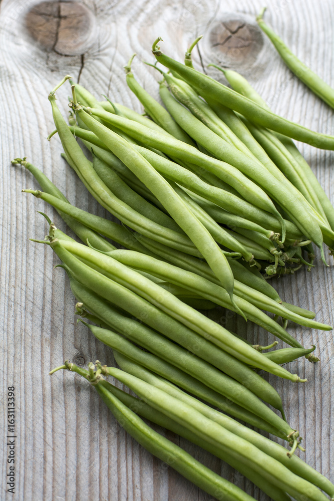 Pile of fresh beans on the wooden background Pile of fresh beans on the wooden background