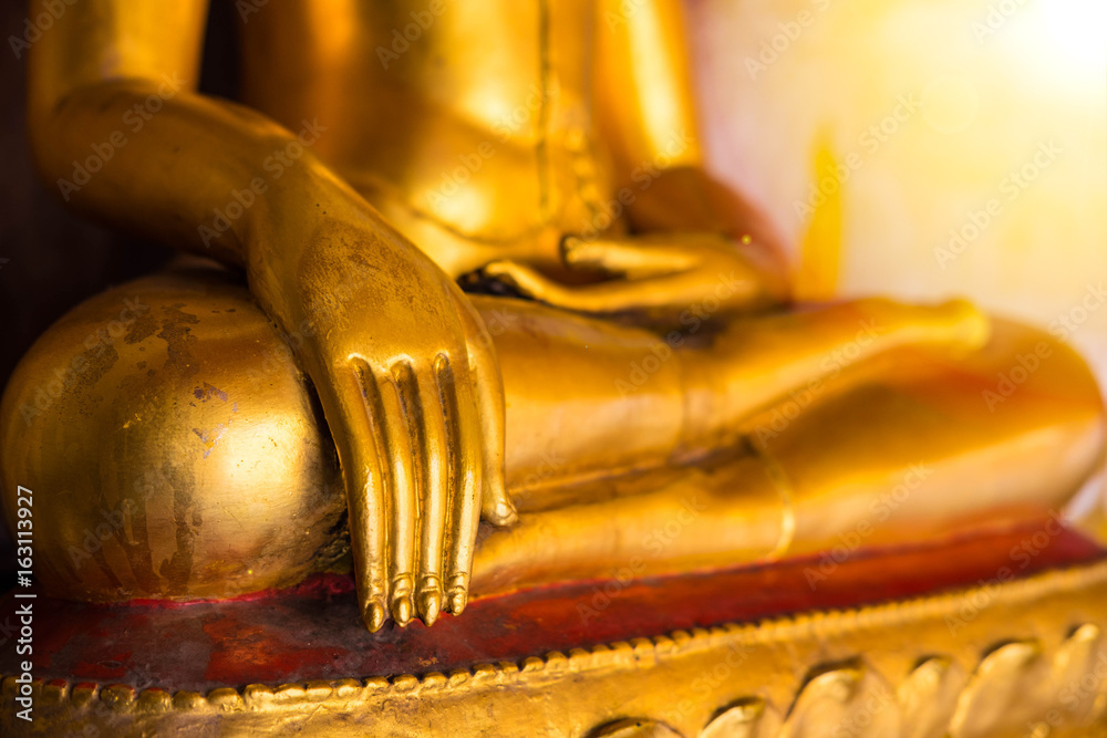 Golden color hand of image of Buddha in old temple of Thailand