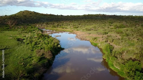 Aerial drone flight over river in uninhabited African nature wilderness