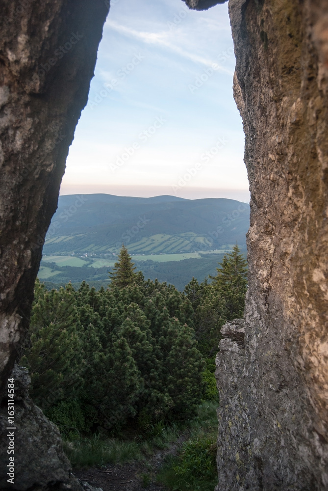 view through natural arch on Cervana hora hill in Jeseniky mountains