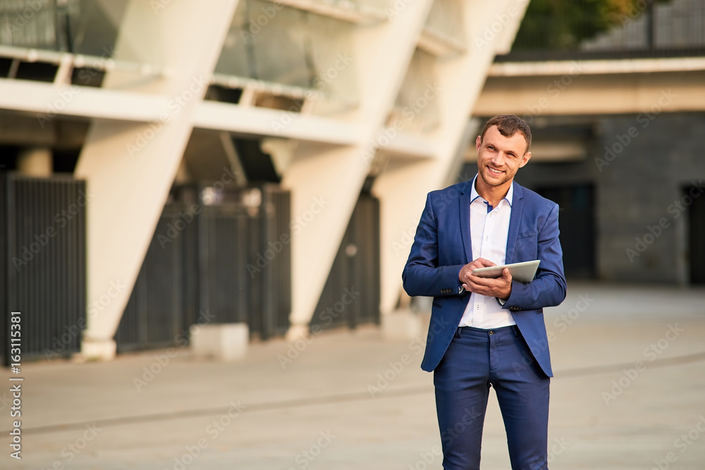Businessman with tablet smiling. Happy young male outdoors. Easy steps to success. Businessman with tablet smiling. Happy young male outdoors. Easy steps to success.