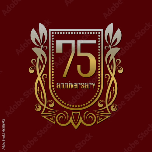 Seventy fifth anniversary vintage logo symbol. Golden emblem with numbers on shield in wreath.