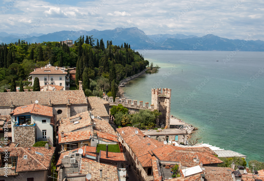 View of colorful old buildings in Sirmione and Lake Garda from Scaliger castle wall, Italy